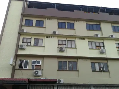 a tall building with windows and air conditioners at HotelMalaya in Taiping