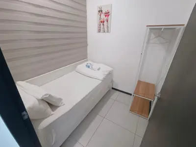 a small white room with a small bed in it at Infinity Pool, Urban Suites, Georgetown, 2 Car Parks by Star Home in George Town