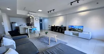 a living room with a couch and a tv on a wall at 218 Macalister Food Paradise By Smart Space Home in George Town