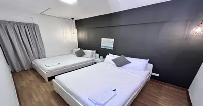 a room with two beds and a black wall at 218 Macalister Food Paradise By Smart Space Home in George Town