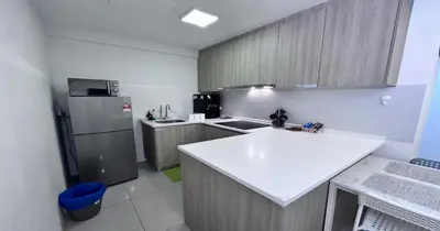 a kitchen with a white counter and a refrigerator at 218 Macalister Food Paradise By Smart Space Home in George Town