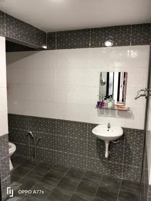 a bathroom with a sink and a toilet and a mirror at RJ design homestay in Kampong Batu Lapan