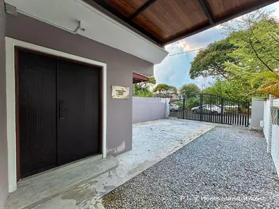 a black door on the side of a house at Bercham Landed CornerLot 6BR with Karaoke Set & BBQ in Ipoh