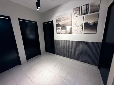 a bathroom with black doors and a tile floor at Babania Spice Stay in Bayan Lepas