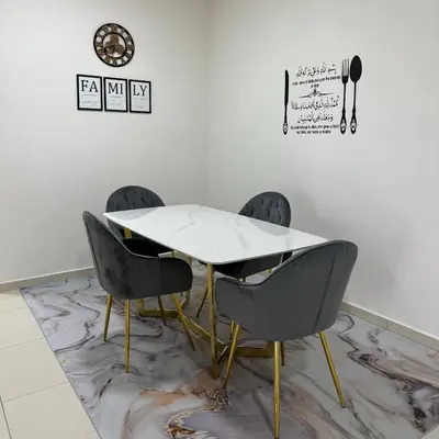 a table and chairs in a room with a wall at Sky9Haven Homestay in Ipoh