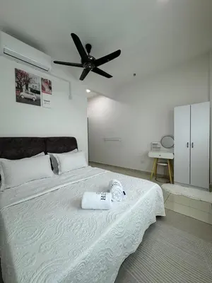 a bedroom with a bed with a ceiling fan at Sky9Haven Homestay in Ipoh