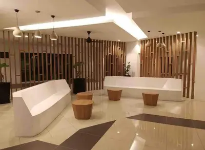a living room with a white couch and wood accents at Meritus in Perai
