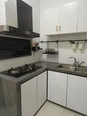 a kitchen with white cabinets and a sink at Meritus in Perai
