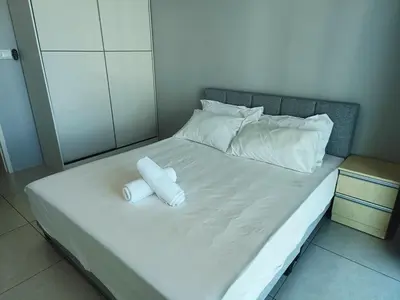 a bed with two rolled up towels on it at Meritus in Perai