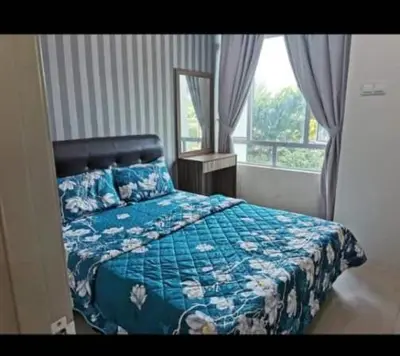 a bedroom with a bed with a blue comforter and a window at DhiyaAdraHomestay in Chemor