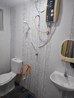 a bathroom with a toilet and a sink at DhiyaAdraHomestay in Chemor
