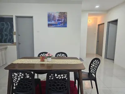 a dining room table and chairs in a room at DhiyaAdraHomestay in Chemor