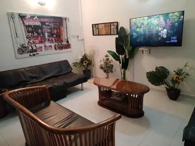 a living room with a couch and a flat screen tv at Gurney PENstay in George Town