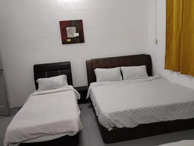 two beds sitting next to each other in a room at Gurney PENstay in George Town