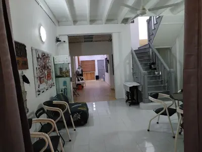 a hallway with a staircase and chairs in a room at Gurney PENstay in George Town