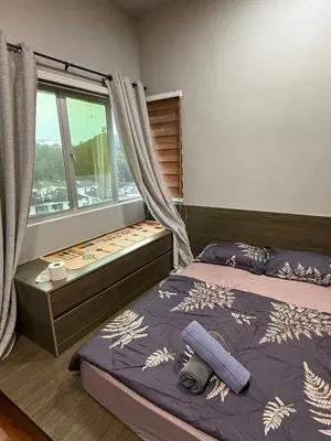 a bedroom with a bed and a window at AYAAN Flora Quintet Apartment & Fifa Home 4 with Free Parking in Tanah Rata