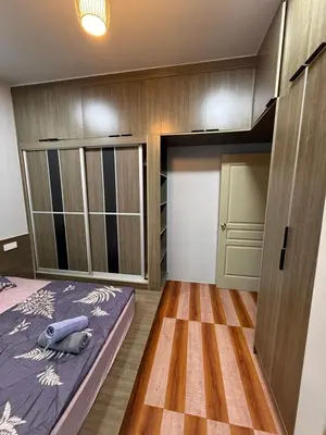 a small room with a bed and a closet at AYAAN Flora Quintet Apartment & Fifa Home 4 with Free Parking in Tanah Rata