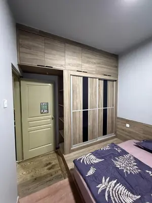 a bedroom with a bed and a large door at AYAAN Flora Quintet Apartment & Fifa Home 4 with Free Parking in Tanah Rata