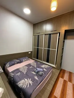 a bedroom with a large bed in a room at AYAAN Flora Quintet Apartment & Fifa Home 4 with Free Parking in Tanah Rata