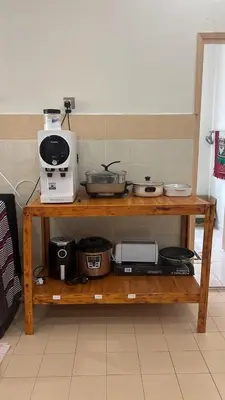 a wooden shelf with various kitchen items on it at Puterihomestay in Gua Sai