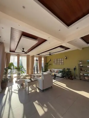 a large living room with a white couch and tables at The Marina View in Gua Sai