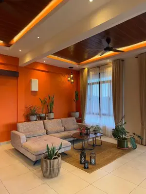 a living room with a couch and a table at The Marina View in Gua Sai
