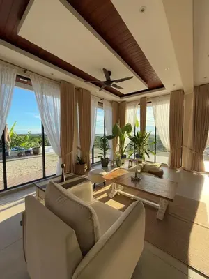 a living room with a couch and a table at The Marina View in Gua Sai