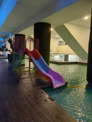 a playground with a slide in the water at Warmth Nest4U Homestay Butterworth in Butterworth