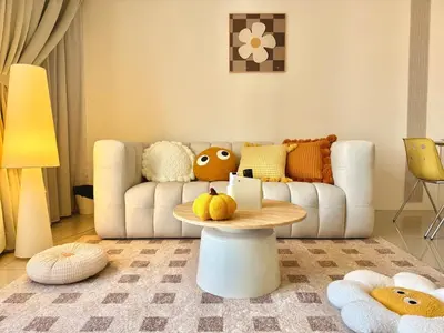 a living room with a couch and a table at Tropicana 218 Macalister #softcreamy #InfinityPool #7pax #3BR2bath #Quality well maintained #Private host in George Town