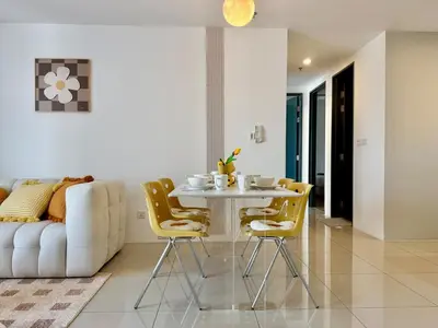 a living room with a table and yellow chairs at Tropicana 218 Macalister #softcreamy #InfinityPool #7pax #3BR2bath #Quality well maintained #Private host in George Town