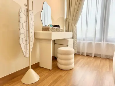 a bathroom with a sink and a mirror and a stool at Tropicana 218 Macalister #softcreamy #InfinityPool #7pax #3BR2bath #Quality well maintained #Private host in George Town