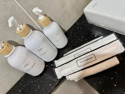 three white bottles on a counter in a bathroom at Tropicana 218 Macalister #softcreamy #InfinityPool #7pax #3BR2bath #Quality well maintained #Private host in George Town