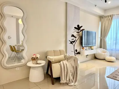 a living room with a chair and a tv at Tropicana 218 Macalister #softcreamy #InfinityPool #7pax #3BR2bath #Quality well maintained #Private host in George Town