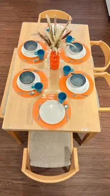 a wooden table topped with plates and dishes on it at Vika Homestay in Brinchang