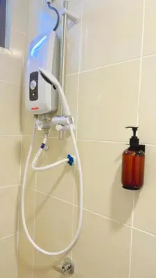 a blow dryer on a wall in a bathroom at Vika Homestay in Brinchang