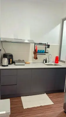 a kitchen with a sink and a counter top at Vika Homestay in Brinchang
