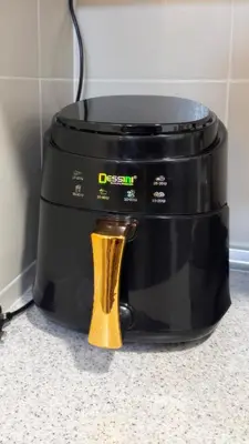 a slow cooker with a yellow spoon in front of it at Vika Homestay in Brinchang