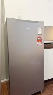 a silver refrigerator sitting in a room at Vika Homestay in Brinchang