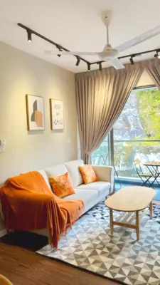 a living room with a couch and a large window at Vika Homestay in Brinchang