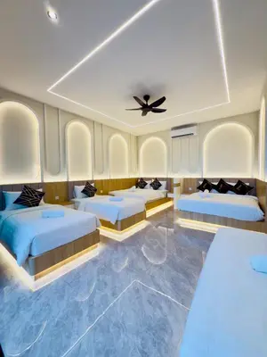 a room with four beds and a ceiling fan at LYL Ipoh Garden Private Pool Villa-18pax 5BR in Ipoh