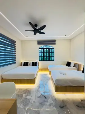 a bedroom with four beds and a ceiling fan at LYL Ipoh Garden Private Pool Villa-18pax 5BR in Ipoh