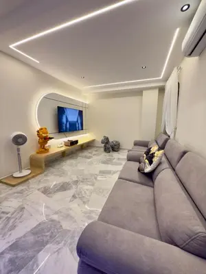 a living room with a couch and a flat screen tv at LYL Ipoh Garden Private Pool Villa-18pax 5BR in Ipoh