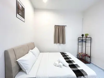 a bedroom with a bed with a black and white blanket at S Home Ipoh in Ipoh