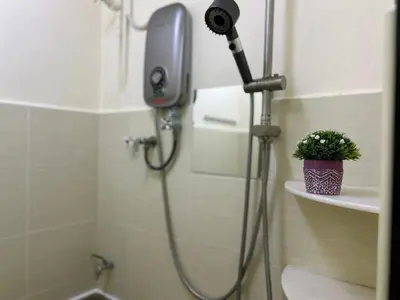 a shower in a bathroom with a blow dryer at S Home Ipoh in Ipoh