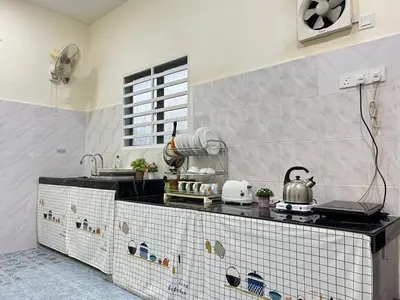 a kitchen with a tiled counter top in a room at S Home Ipoh in Ipoh