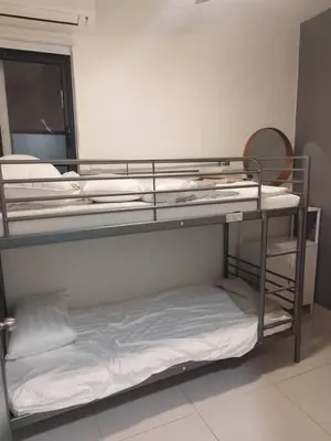 two bunk beds in a room with a mirror at Dynamic capsule in Gua Sai