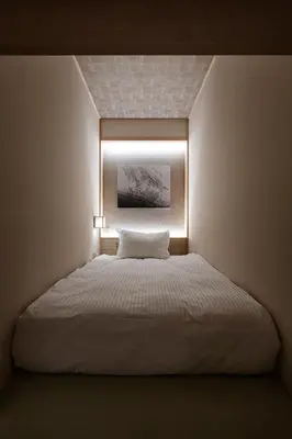 a bedroom with a bed with a light on it at Dynamic capsule in Gua Sai
