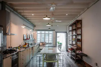 a large kitchen with a table and stools in it at Ah Tong Residence - 3 mins to Kimberley Night Market in George Town