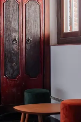 a wooden door with a table and a green chair at Ah Tong Residence - 3 mins to Kimberley Night Market in George Town