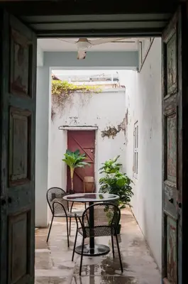 a patio with a table and chairs in a room at Ah Tong Residence - 3 mins to Kimberley Night Market in George Town